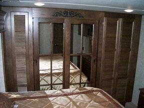 The bedroom has an entertainment center and a large closet.