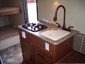 Stove and sink with high arch sprayer faucet